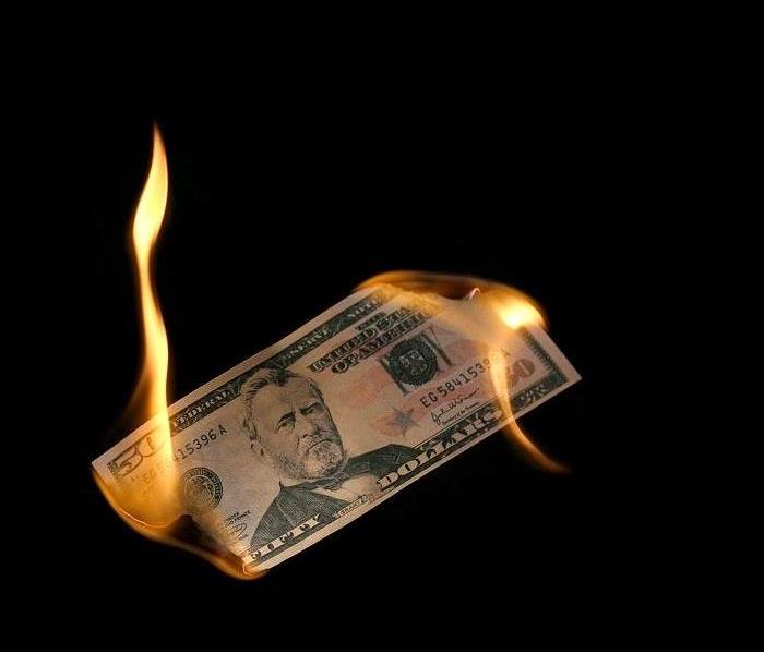 $50 bill being burned at both ends