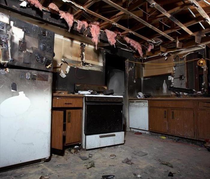 damaged kitchen with insulation hanging