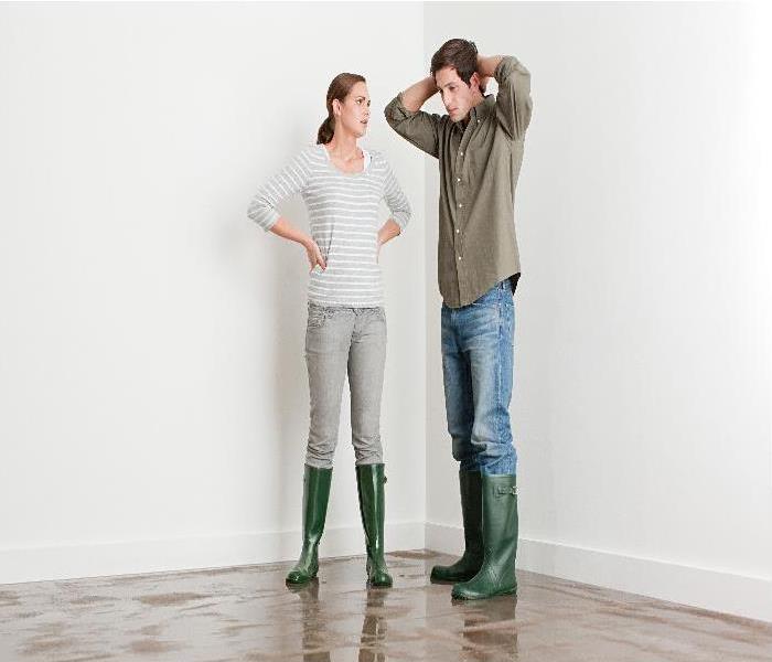 Young couple on flooded floor