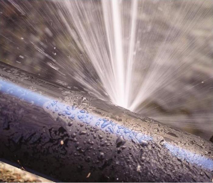 leaking pipe spewing water