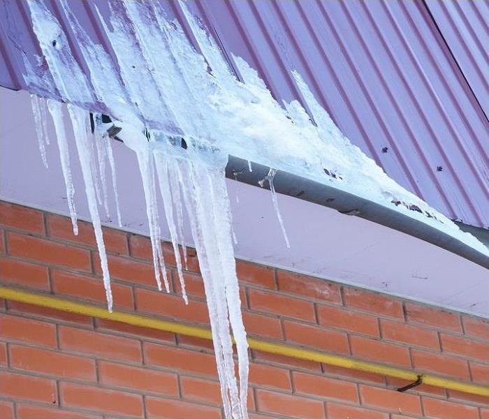 Ice dam on roof; icicles on gutter and roof