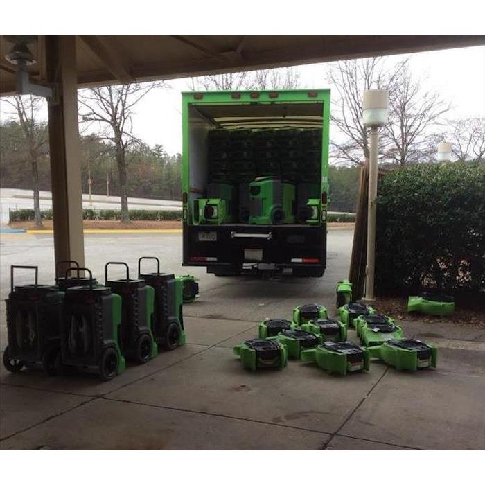 SERVPRO box truck with equipment in the truck and on the sidewalk