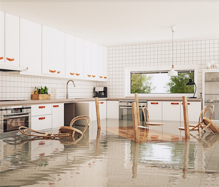 a flooded kitchen with furniture floating around